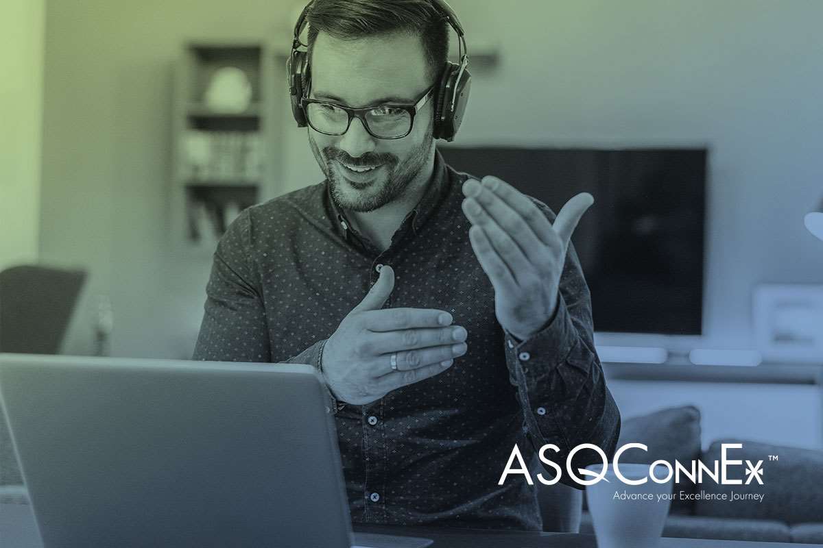 Man with headphones and laptop computer gesturing